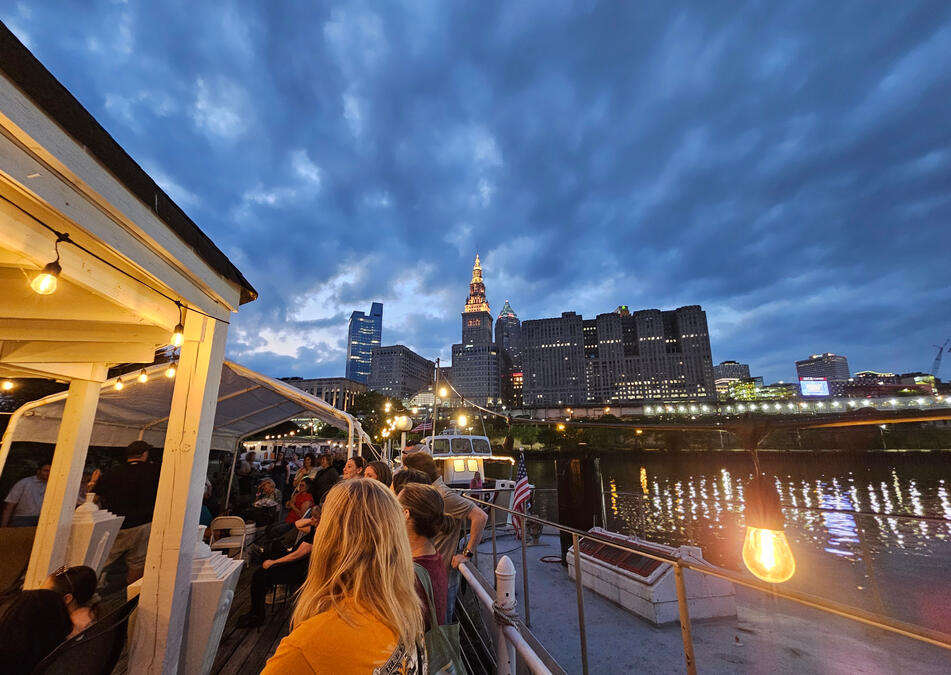 A view of he Cleveland Skyline at dusk on the Cuyahoga River from a dock.