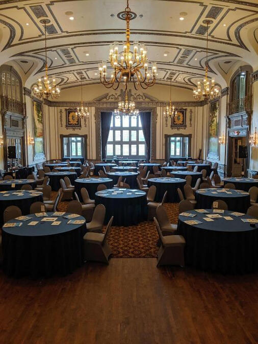 The Tudor Arms Hotel ballroom set up for an event with blue tablecloths.