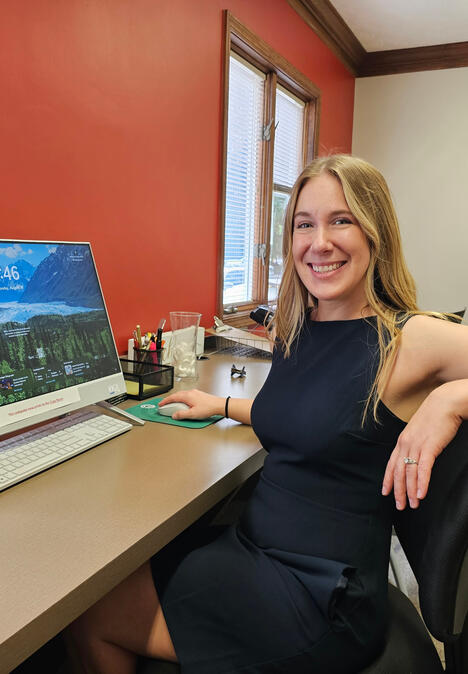 Untitled Northeast Ohio Realtor Sarah Jobin Spaller smiling at her desk in the Limitless Real Estate Group office.